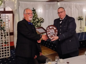 Chas presenting the forces trophy shield to 1404 Squadron OC